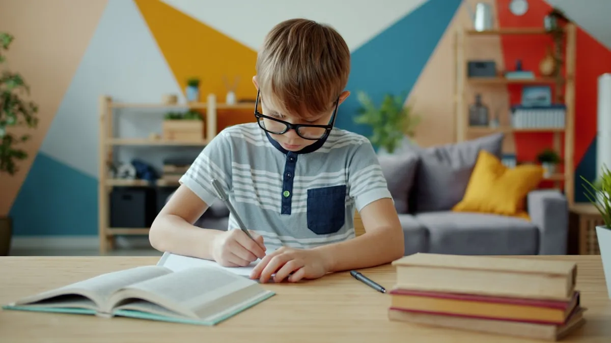 Young boy writing focused at desk with notebook and learning materials