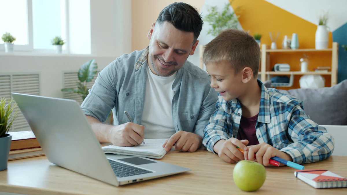 Parent and child working together at a table with homework and a laptop