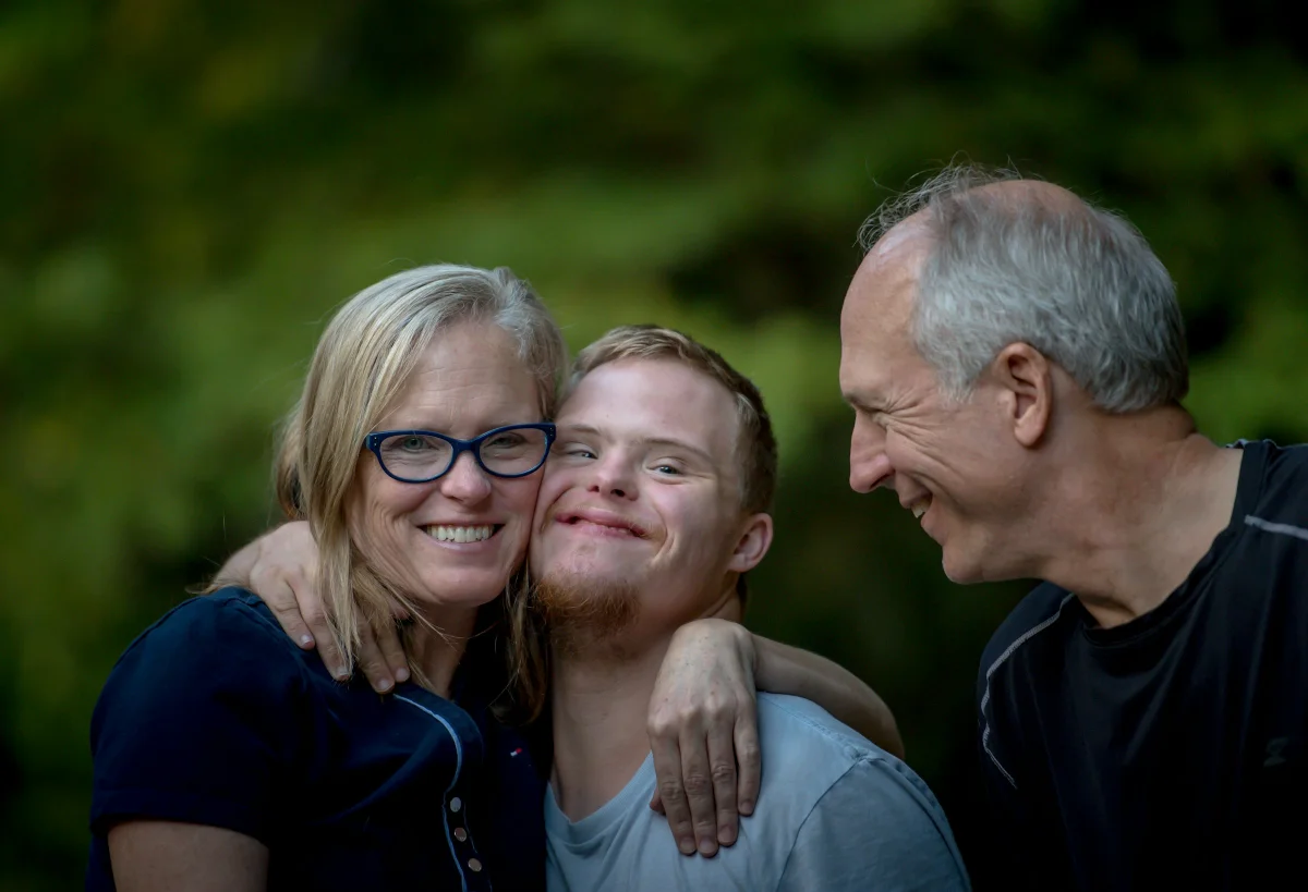 A child with special needs smiling while engaging with an activity