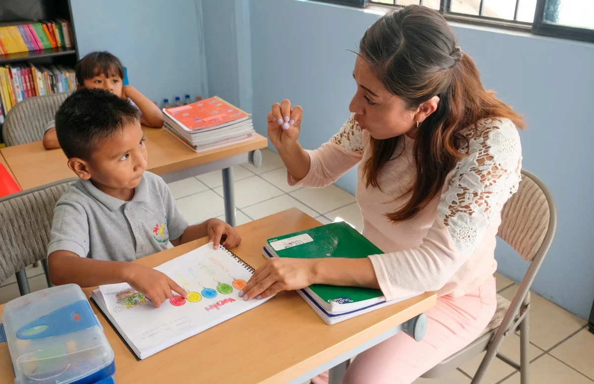 A teacher working one-on-one with a student in a classroom
