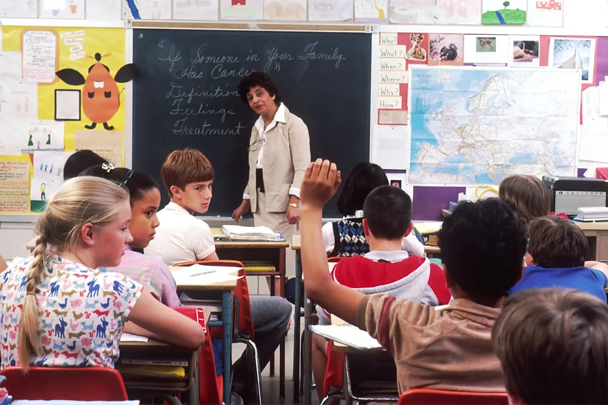 Woman standing in front of children in a classroom