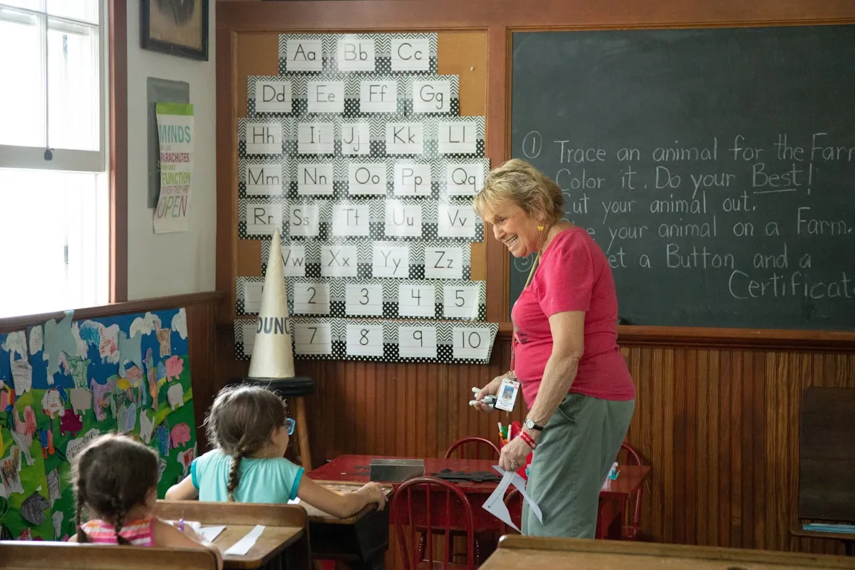 Woman standing beside a young boy, informal interaction in a bright setting